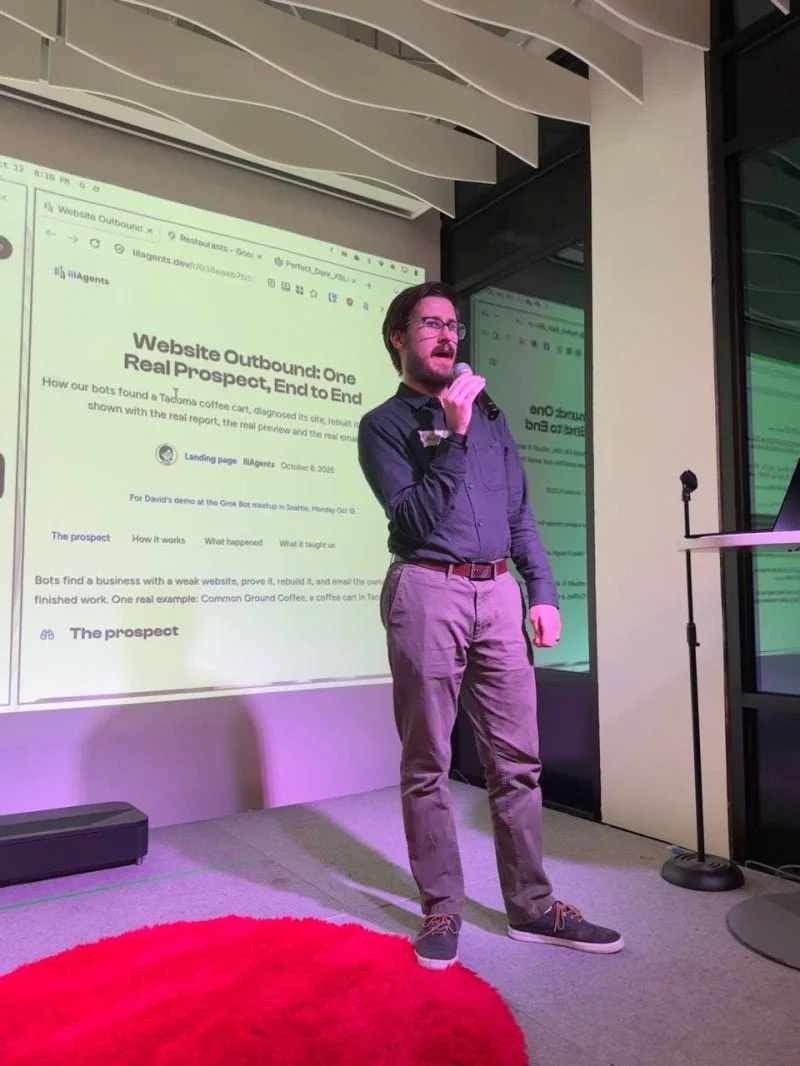 David speaking into a microphone at the Grok Bot meetup in Seattle