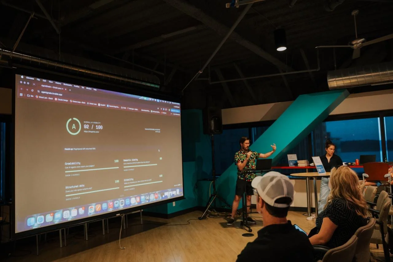 David demoing an AI visibility grader on a big screen