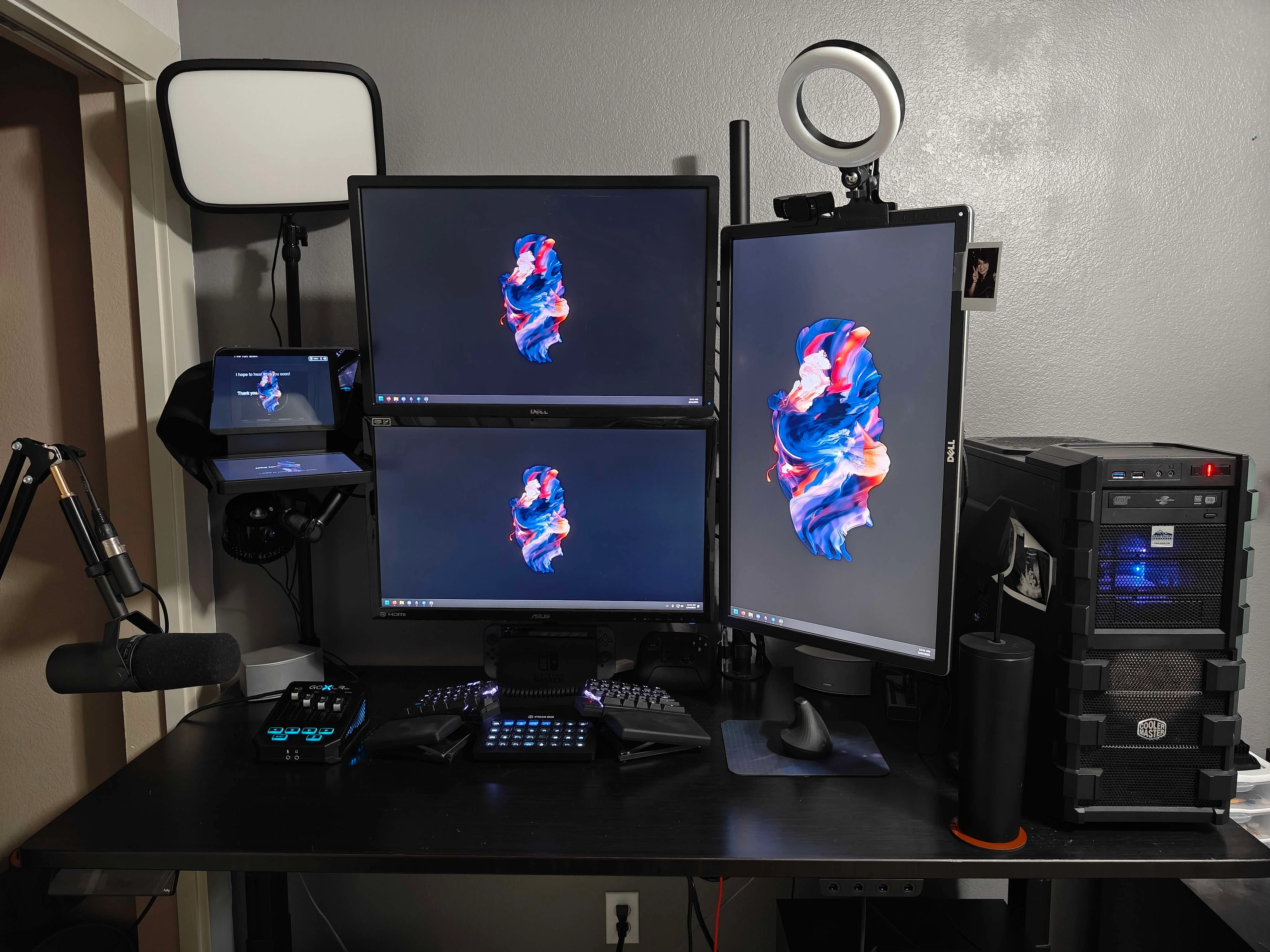 Full desk setup with monitors and production gear